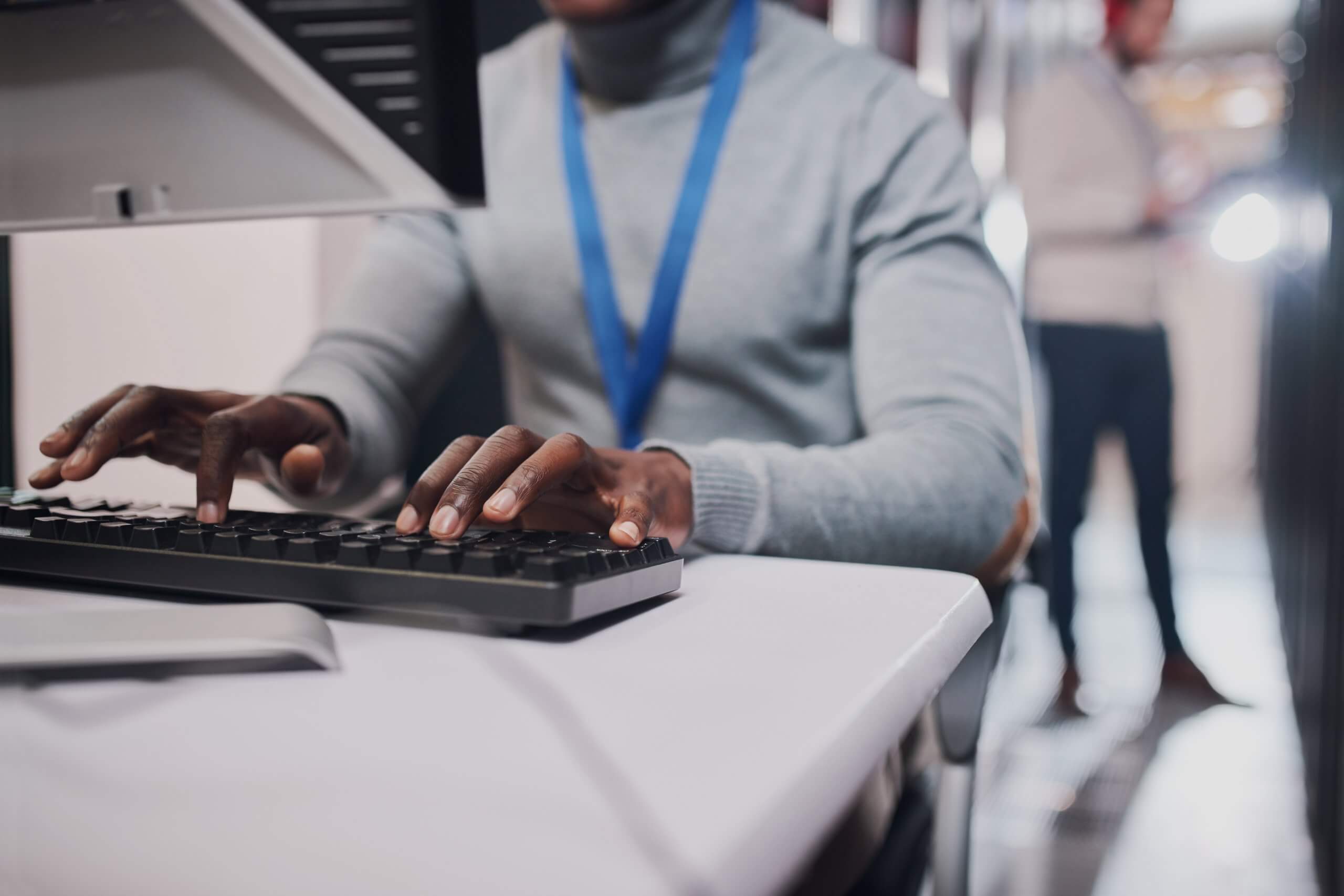 Closeup shot of an unrecognisable man working on a computer in a data center